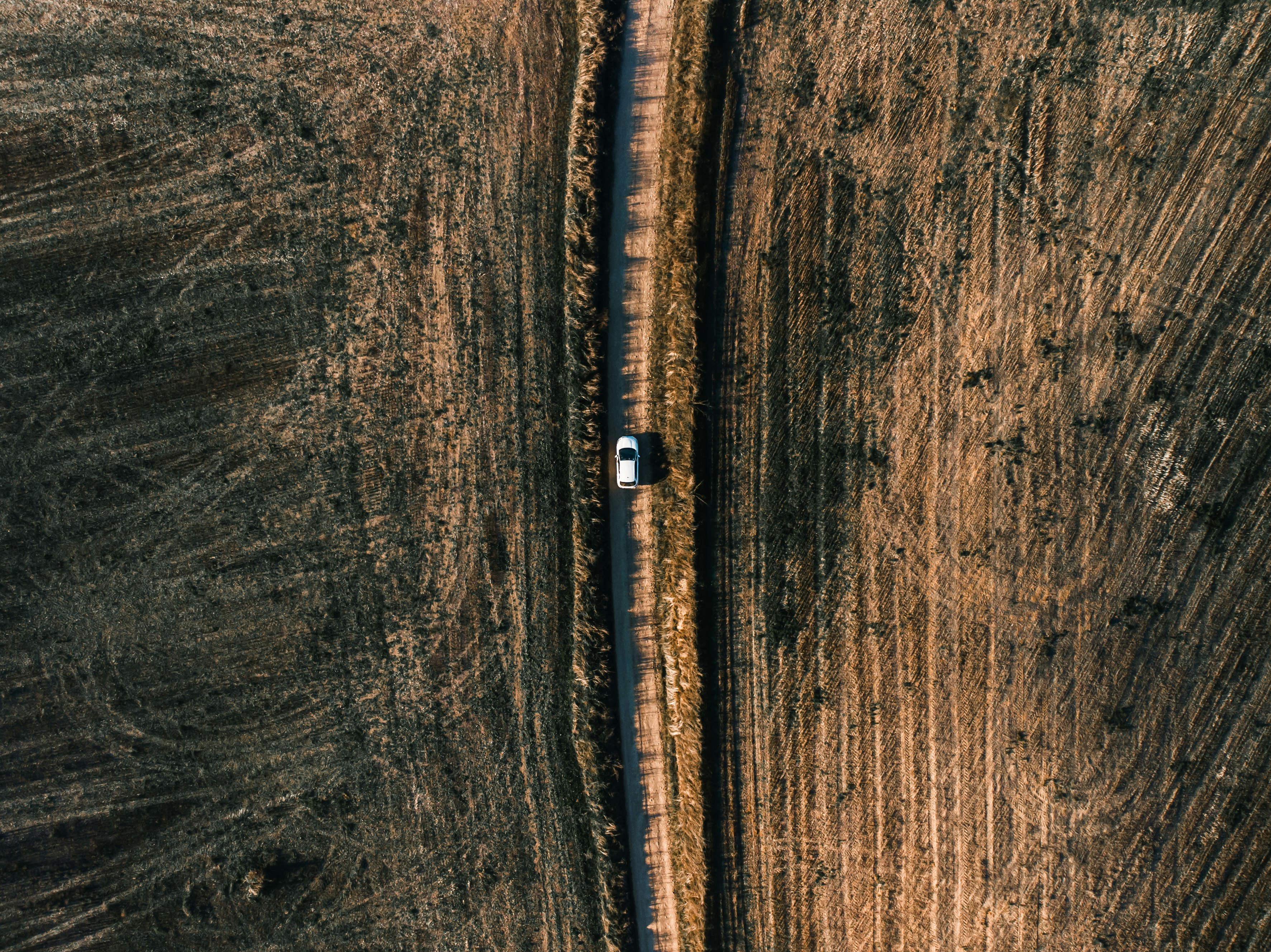 white vehicle on road in aerial photography